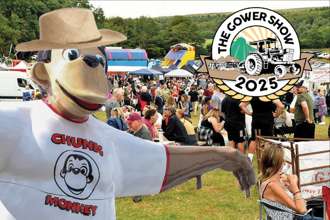 Chunk Monkey at the Gower Show 2025, featuring Chunk wearing a straw hat with the festival in the background.
