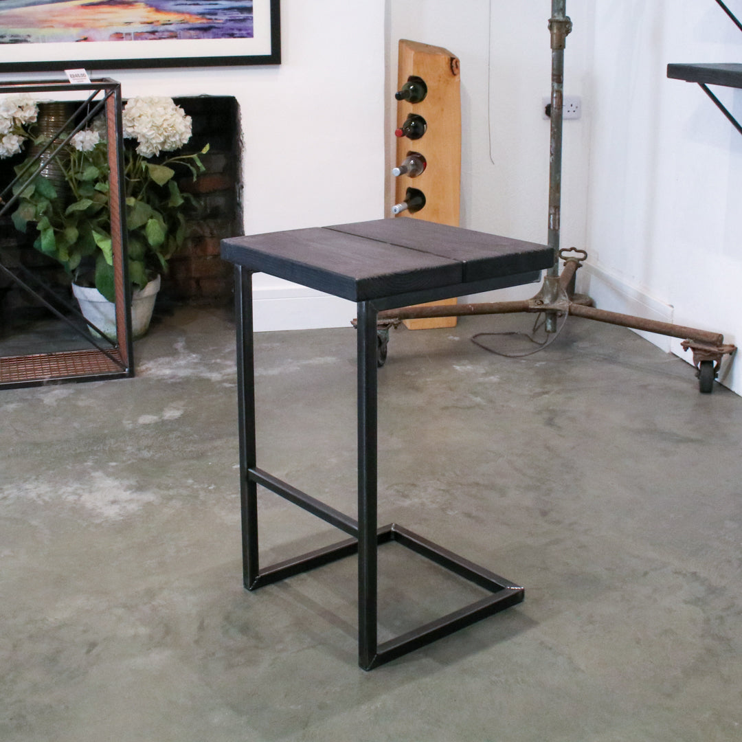 Rustic industrial stool with footrest and Extra Chunky charcoal seat on a high cantilever frame.