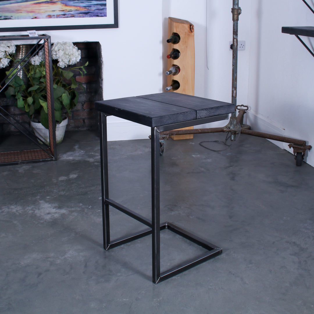 Rustic industrial stool with footrest and Extra Chunky charcoal seat on a high cantilever frame.