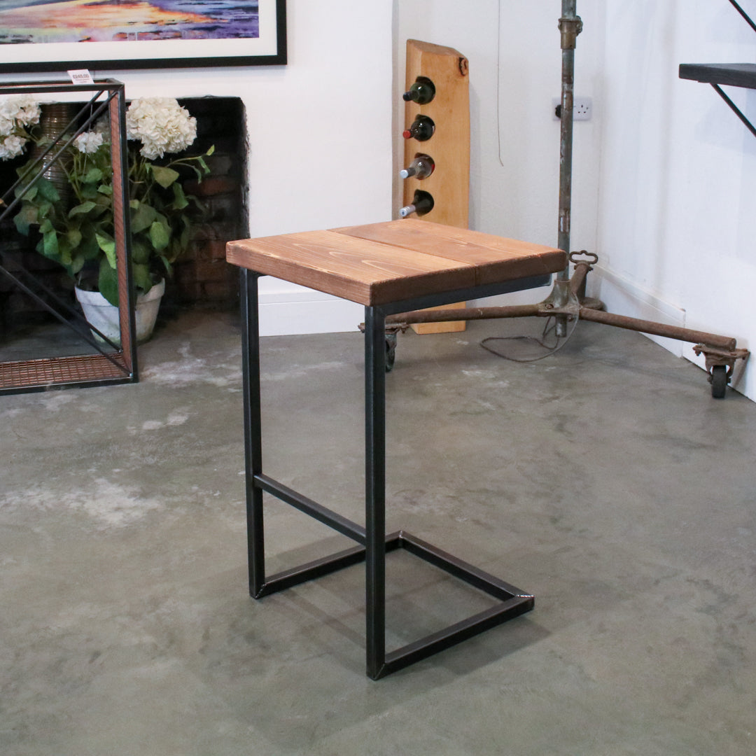 Rustic industrial stool with footrest and Extra Chunky light walnut seat on a high cantilever frame.