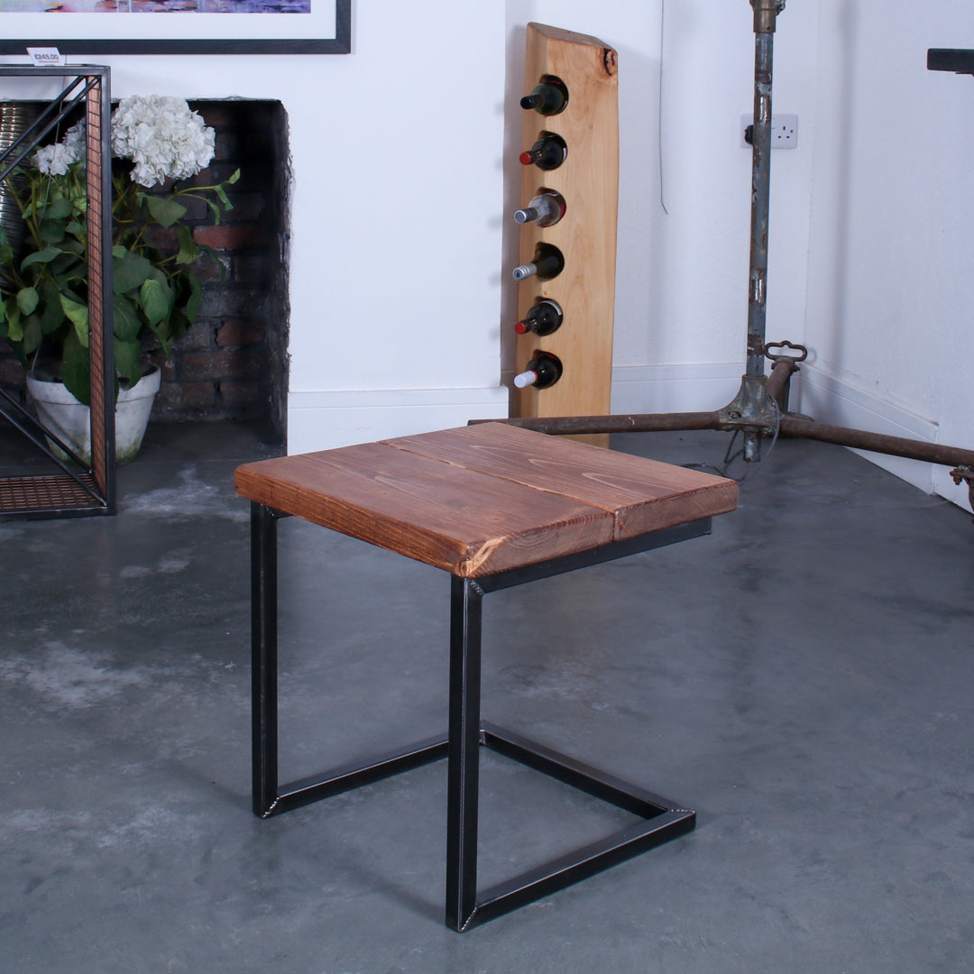 Rustic industrial stool with footrest and Extra Chunky light walnut seat on a low cantilever frame.