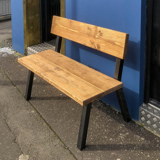 close up shot from right side of the rustic industrial extra chunky farmhouse bench shot outside of our Swansea shop