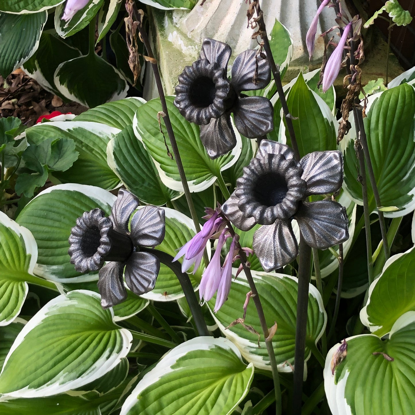 trio of ornamental metal daffodils side view