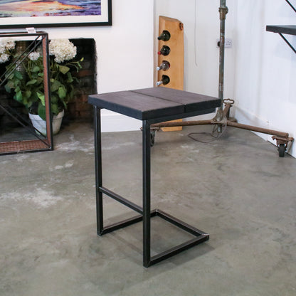 Rustic industrial stool with footrest and Extra Chunky charcoal seat on a high cantilever frame.