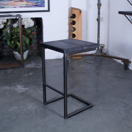 Rustic industrial stool with footrest and Extra Chunky charcoal seat on a high cantilever frame.