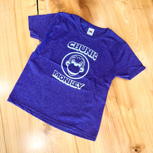 Dark heather purple t-shirt with 'Chunk Monkey' design on a wooden surface