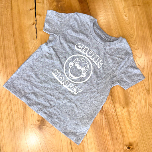 Gray t-shirt with 'Chunk Monkey' logo on a wooden surface