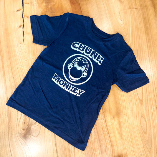Navy t-shirt with 'Chunk Monkey' logo on a wooden surface