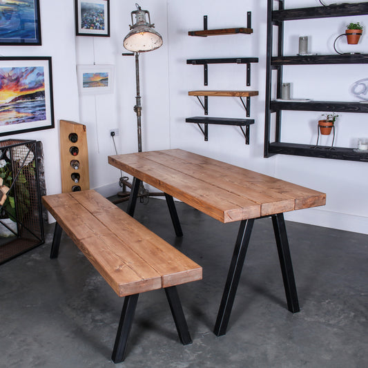 Farmhouse stained Extremely Chunky 3 board solid wood dining table with a bench, both featuring 'Chunk Two' legs in rustic industrial room