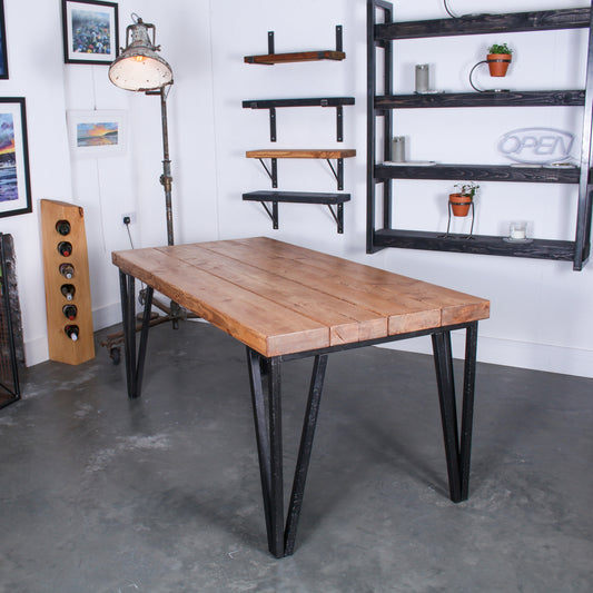 Farmhouse stained dining table made from four 'Extremely Chunky' boards with chunkiest hairpin legs in a rustic industrial setting