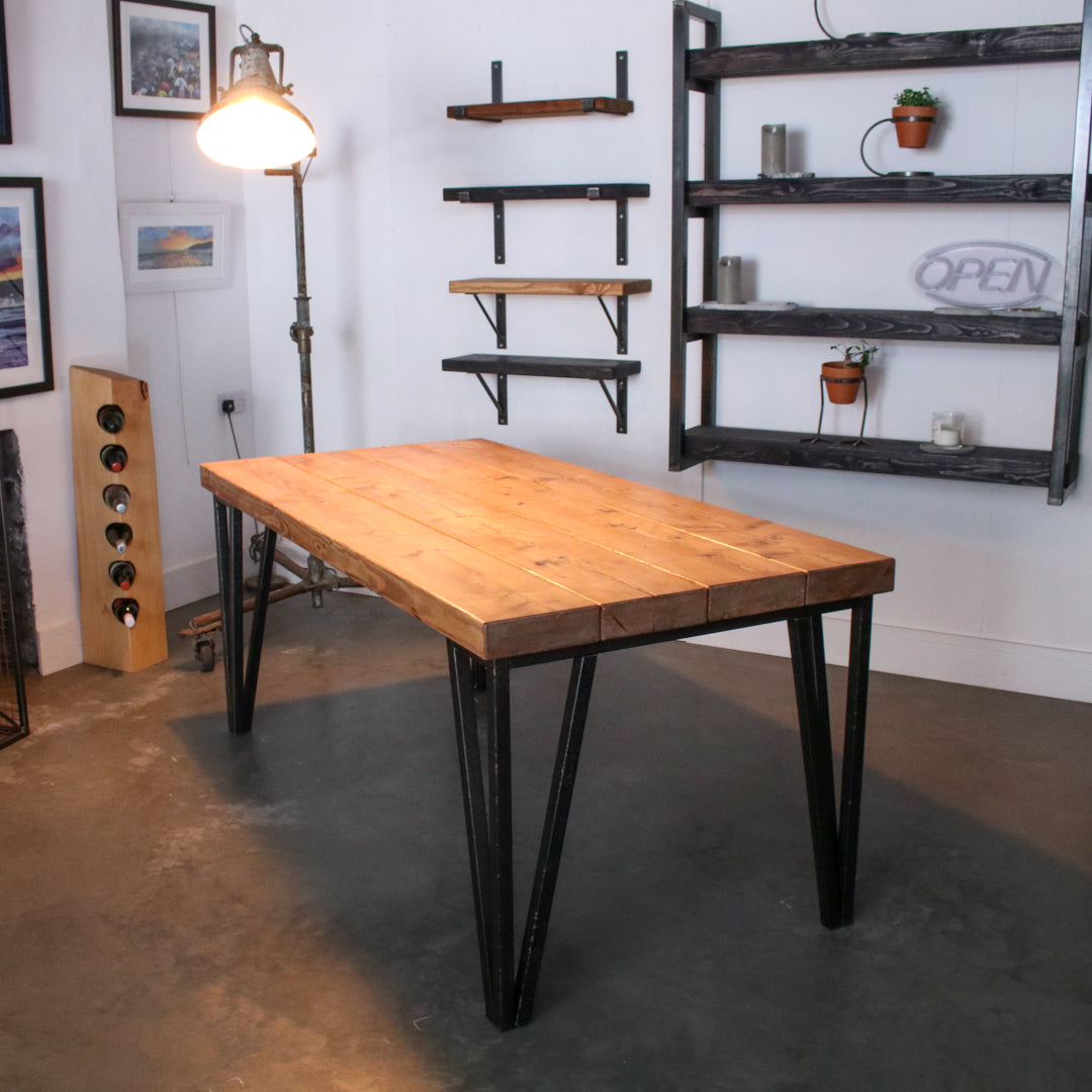 Farmhouse stained dining table made from 4 'Extremely Chunky' boards with hairpin legs in a rustic industrial setting