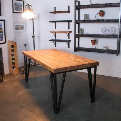 Farmhouse stained dining table made from 4 'Extremely Chunky' boards with hairpin legs in a rustic industrial setting