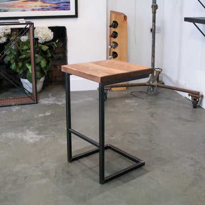 Rustic industrial stool with footrest and Extra Chunky light walnut seat on a high cantilever frame.