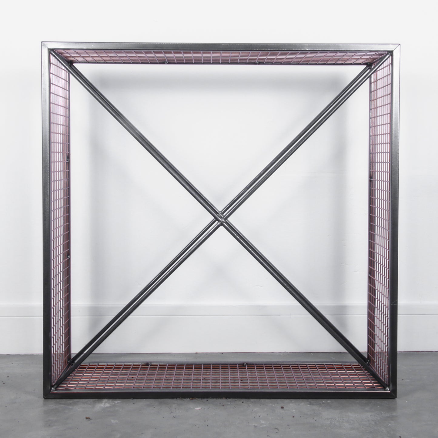Empty metal firewood holder against a white background
