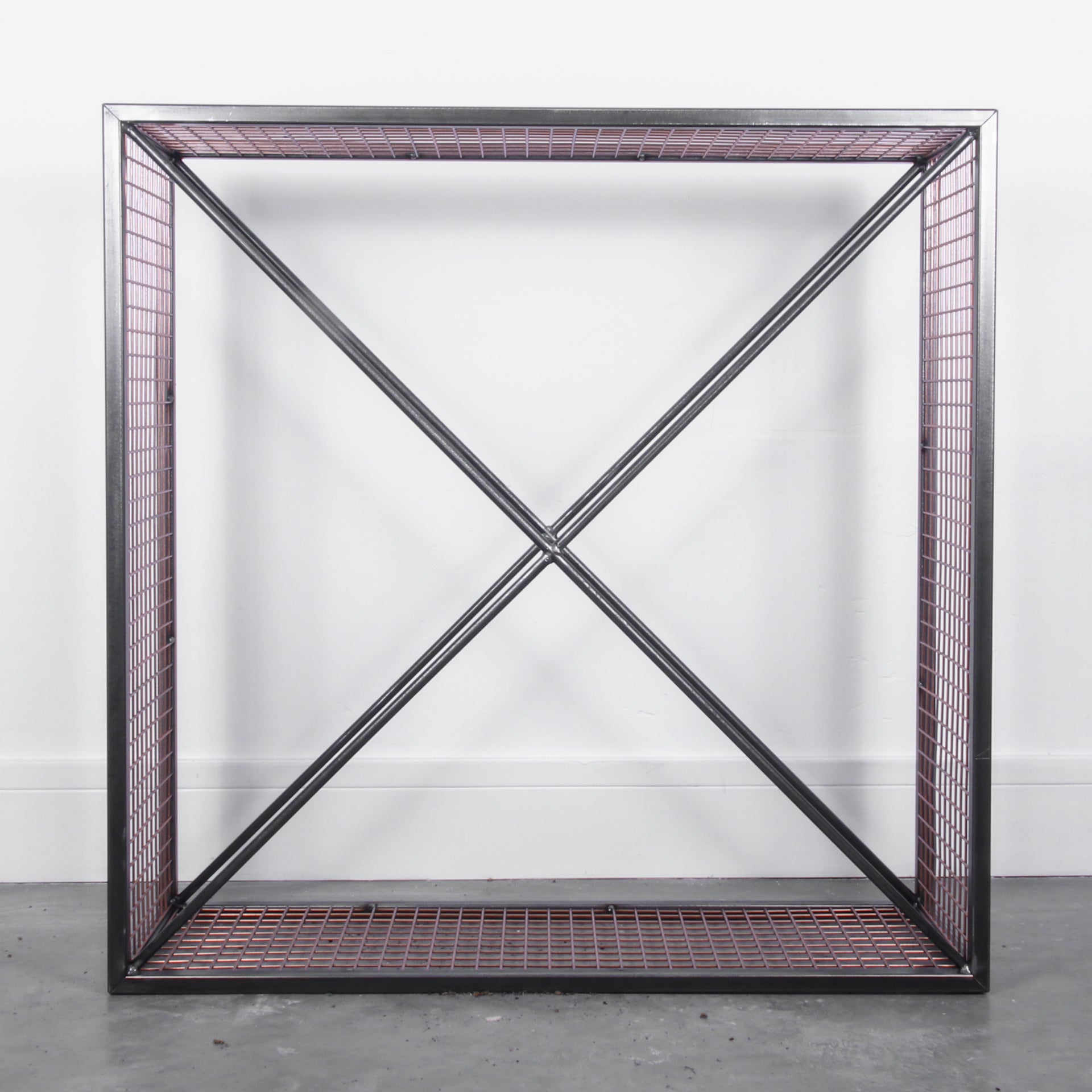 Empty metal firewood holder against a white background