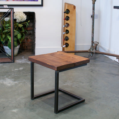 Rustic industrial stool with footrest and Extra Chunky walnut seat on a low cantilever frame.