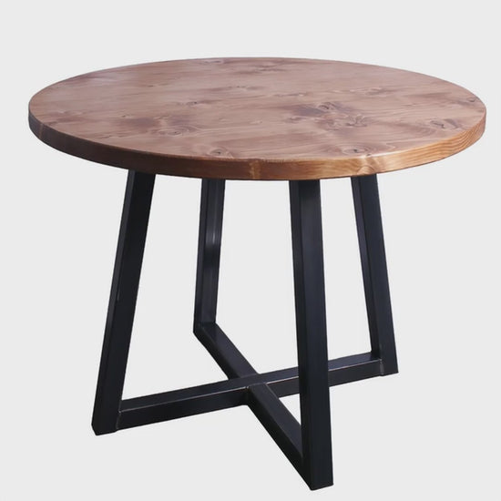 A 3D view of a round table with quadpod legs rotating in a studio setting